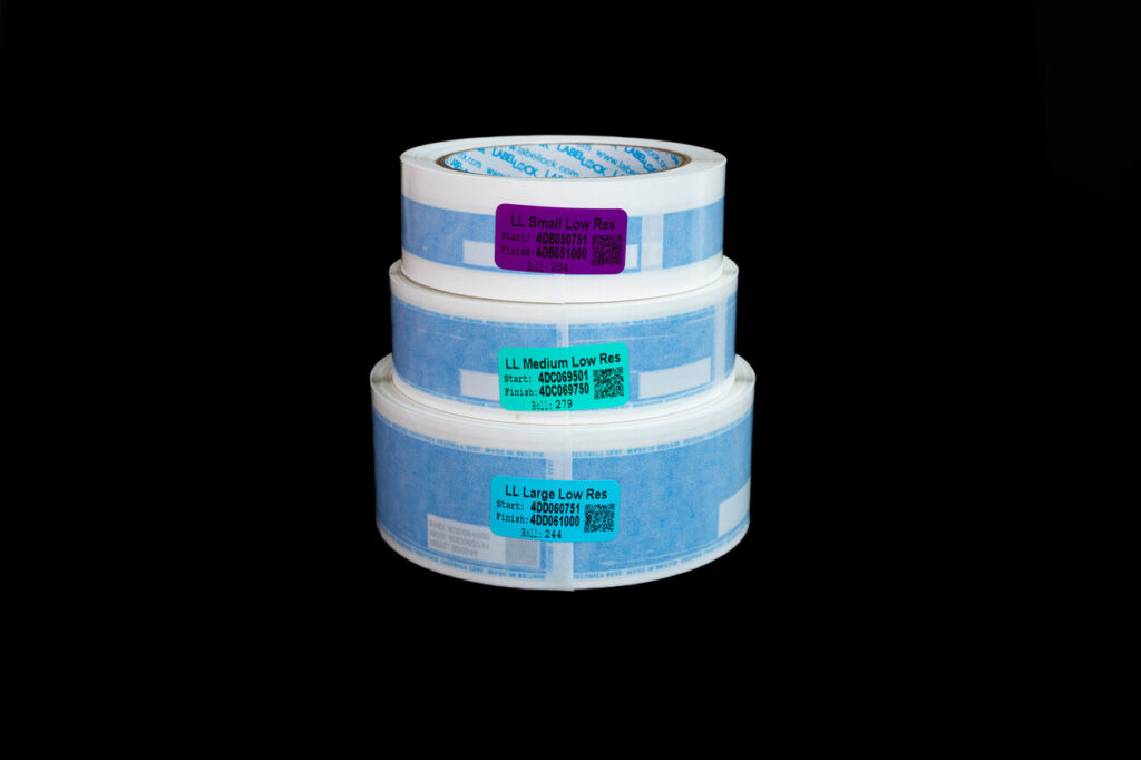 Stack of 3 reels of No Residue LabelLock® labels - showing one of each size