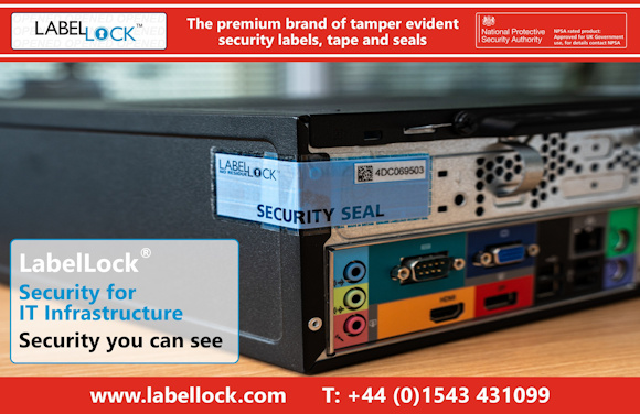 Image promoting LabelLock® tamper-evident security seals. A close-up of the rear panel of a desktop computer shows a blue semi-transparent No Residue LabelLock® tamper evident security label placed across the chassis opening, displaying a serial number and QR code. The image highlights protection for IT infrastructure. Branding at the top reads “The premium brand of tamper evident security labels, tape and seals,” with a UK National Protective Security Authority approval badge. Text in the lower left corner states, “LabelLock®. Security for IT Infrastructure. Security you can see.” Contact details and the website www.labellock.com appear along the bottom.