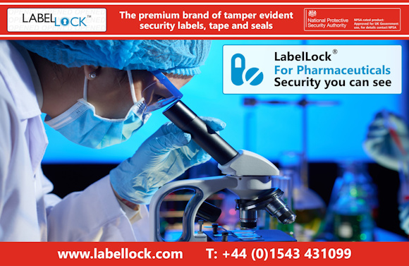 Promotional image for LabelLock® tamper evident security labels, tape and seals featuring a close-up image of a research scientist in a lab, wearing a lab coat, hair net and face mask, peering through a microscope at a sample on a slide, with lab equipment shown in the background, representing pharmaceutical research. The banner reads “LabelLock® For Pharmaceuticals. Security you can see” and highlights LabelLock® as “The premium brand of tamper evident security labels, tape and seals.” The image includes the National Protective Security Authority approval badge, the website www.labellock.com, and contact number +44 (0)1543 431099.