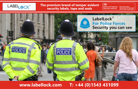 Promotional image for LabelLock® tamper evident security labels, tape and seals featuring two British Policemen wearing high visibility Police jackets standing on a busy street corner, on the look out for criminal activity. The banner reads “LabelLock® For Police Forces. Security you can see” and highlights LabelLock® as “The premium brand of tamper evident security labels, tape and seals.” The image includes the National Protective Security Authority approval badge, the website www.labellock.com, and contact number +44 (0)1543 431099.